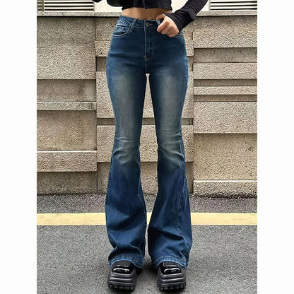 Person wearing blue flared jeans standing against a textured wall. Women’s high waist flared jeans, stretchy bootcut denim trousers. Thin fabric, solid color, bell bottoms style for casual chic UK fashion.