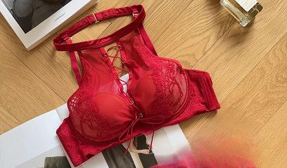 Red bralette on a wooden surface with a magazine underneath