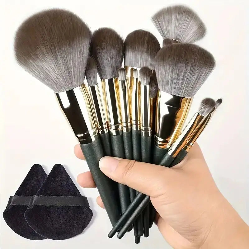 Set of makeup brushes with black handles and gold accents held by a hand, with a black brush holder on a white background. Soft fluffy makeup brush set with wool fiber bristles and plastic handles. Complete set for powder, foundation, eyeshadow, and beauty blending.