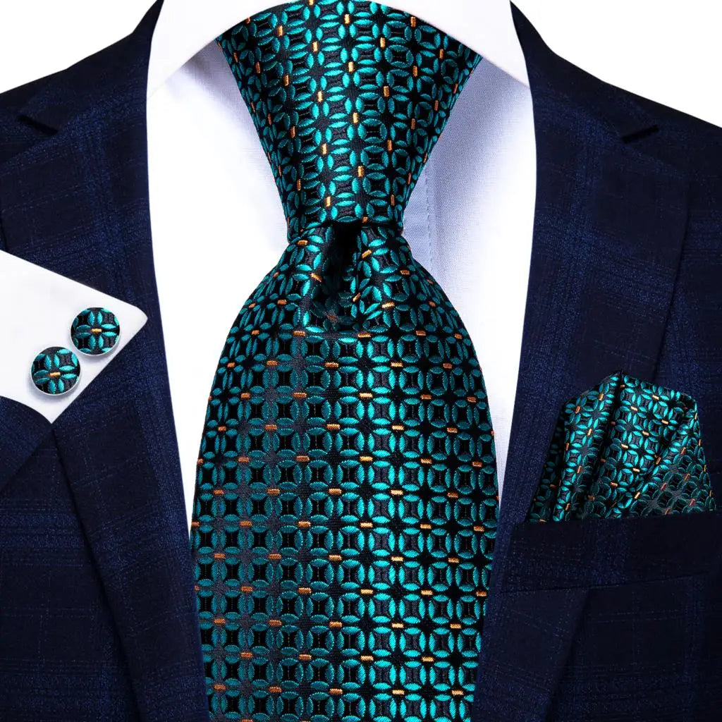 Teal patterned tie with matching cufflinks and pocket square on a suit. Men’s luxury paisley silk tie and pocket square set, 8.5cm wide, for business or wedding. Red formal necktie, ftf fashion UK.