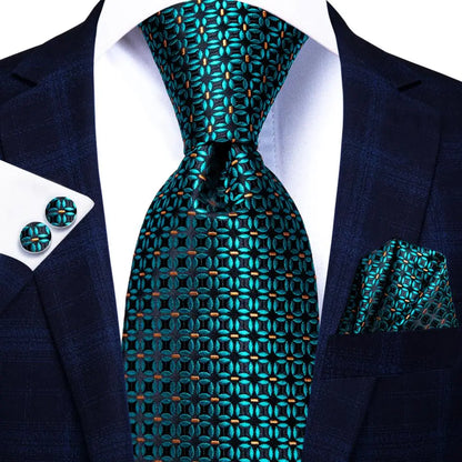 Teal patterned tie with matching cufflinks and pocket square on a suit. Men’s luxury paisley silk tie and pocket square set, 8.5cm wide, for business or wedding. Red formal necktie, ftf fashion UK.