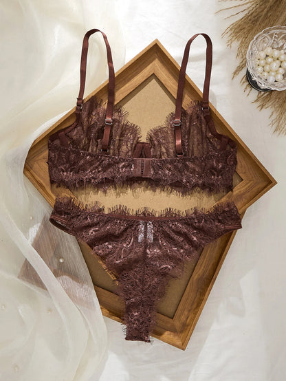 Brown lace lingerie set on a wooden tray with a soft white background