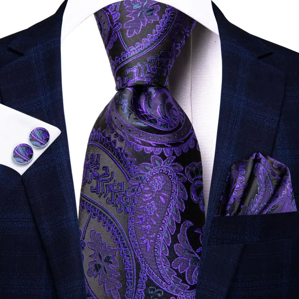 Navy suit with purple paisley tie, pocket square, and cufflinks on a white background. Men’s luxury paisley silk tie and pocket square set, 8.5cm wide, for business or wedding. Red formal necktie, ftf fashion UK.