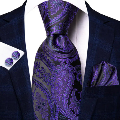 Navy suit with purple paisley tie, pocket square, and cufflinks on a white background. Men’s luxury paisley silk tie and pocket square set, 8.5cm wide, for business or wedding. Red formal necktie, ftf fashion UK.