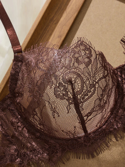 Brown lace bra on a wooden surface