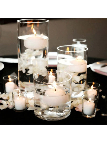 Decorative candles in glass holders on a table with a dark background