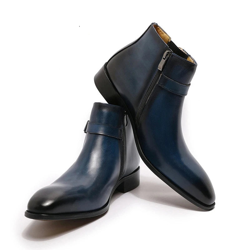 Pair of navy blue leather boots with a zipper on a white background