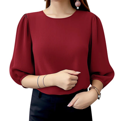 Red blouse with puffed sleeves worn by a person on a white background