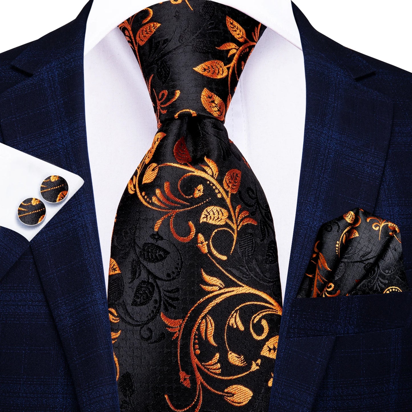 Navy suit with black floral tie, pocket square, and cufflinks on a white background. Men’s luxury paisley silk tie and pocket square set, 8.5cm wide, for business or wedding. Red formal necktie, ftf fashion UK.