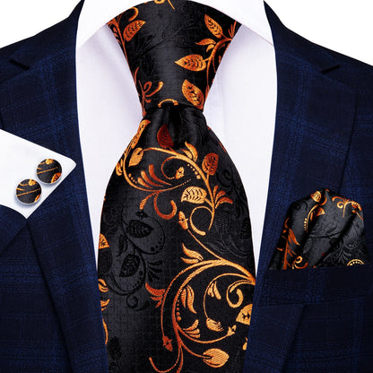Navy suit with black floral tie, pocket square, and cufflinks on a white background. Men’s luxury paisley silk tie and pocket square set, 8.5cm wide, for business or wedding. Red formal necktie, ftf fashion UK.