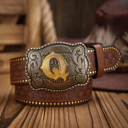Brown leather belt with a gold and silver 'Q' buckle on a wooden surface.