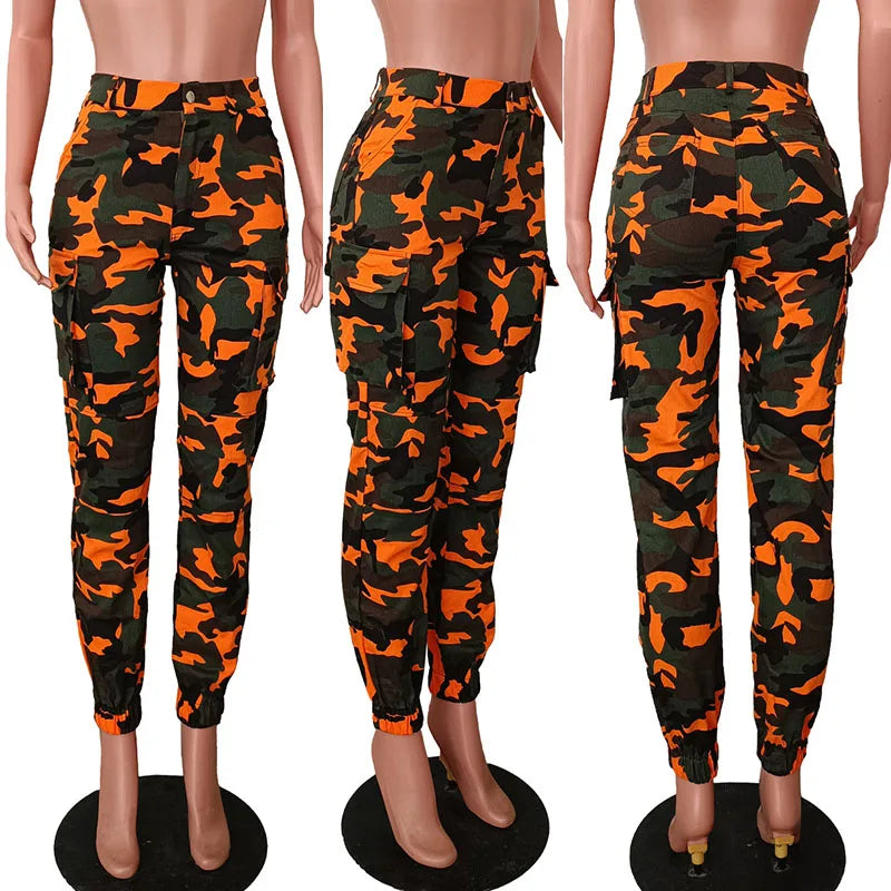 Orange and black camouflage pants displayed on mannequins against a white background