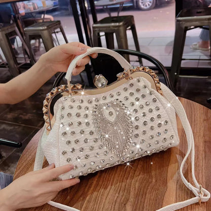 Decorative handbag with rhinestones held by a person in a casual setting. Large genuine leather dumpling bag with diamond rhinestone clip and lock clasp. Soft handle, multiple compartments. Fashionable shoulder tote for women.