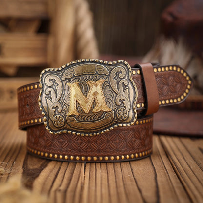Brown leather belt with gold 'M' buckle on a wooden surface