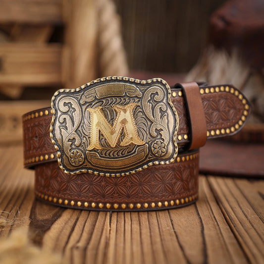 Brown leather belt with gold 'M' buckle on a wooden surface