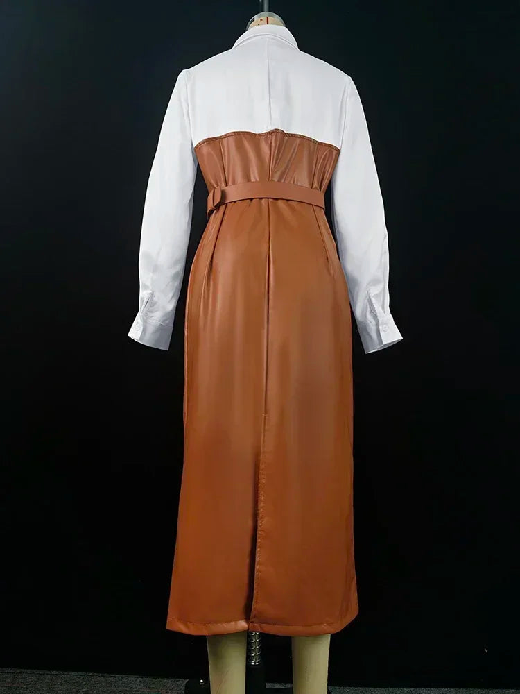 Brown leather dress over a white shirt on a mannequin against a black background