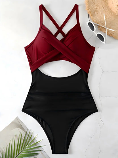 Black and red swimsuit with sunglasses and a hat on a light background