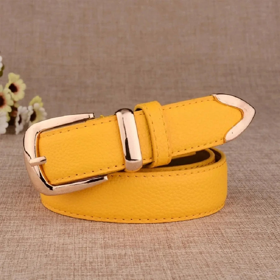 Yellow belt with a gold buckle on a textured brown surface. Women’s vintage white leather trouser belt with solid pin buckle. Stylish, high-quality accessory for fashion-forward looks, UK.