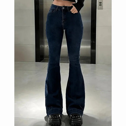 Person wearing blue flared jeans in a bathroom setting. Women’s high waist flared jeans, stretchy bootcut denim trousers. Thin fabric, solid color, bell bottoms style for casual chic UK fashion.