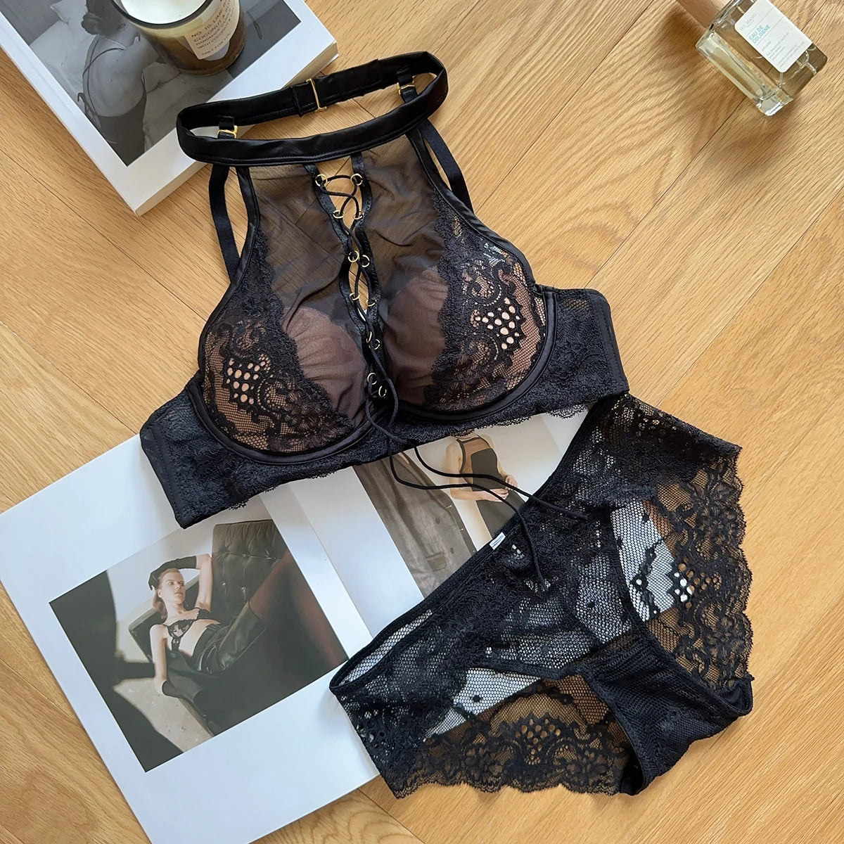 Black lace lingerie set on a magazine with a wooden surface background