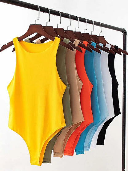 Yellow bodysuit on a hanger with other colored bodysuits on a rack against a white background