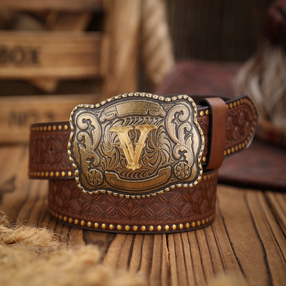 Brown leather belt with decorative buckle on a wooden surface