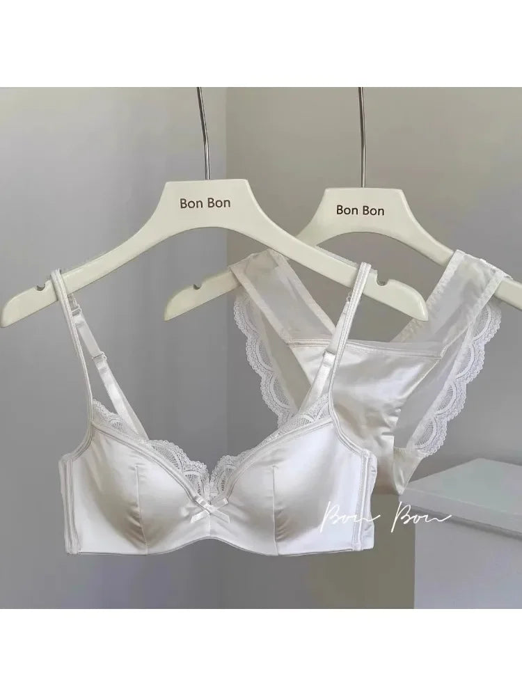 White lace bra on a hanger with 'Bon Bon' branding against a neutral background