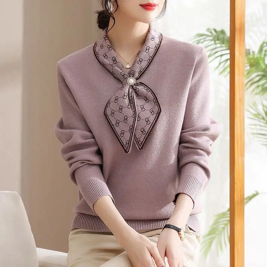 Person wearing a light purple sweater with a decorative collar in an indoor setting.