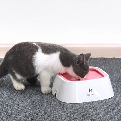 Cat drinking from a pink and white pet bowl on a gray carpet.