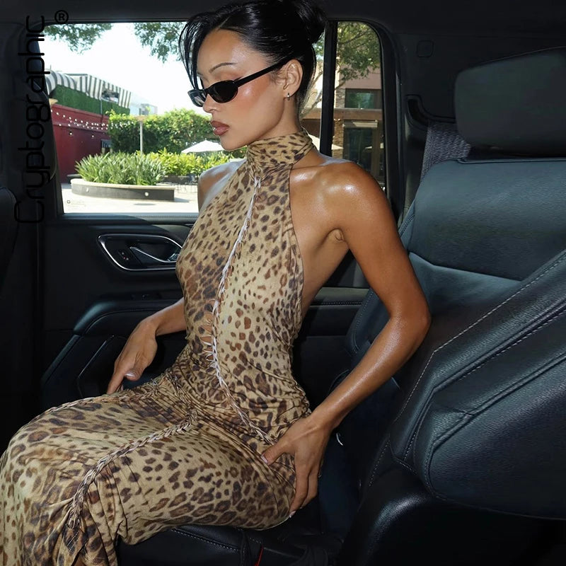 Woman in a leopard print dress sitting in a car