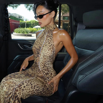 Woman in a leopard print dress sitting in a car
