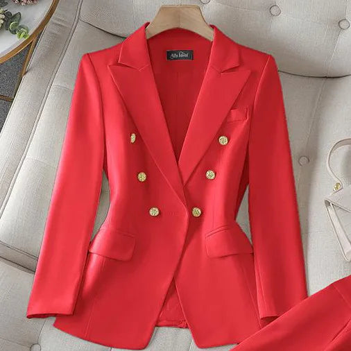 Red blazer with gold buttons on a hanger against a neutral background