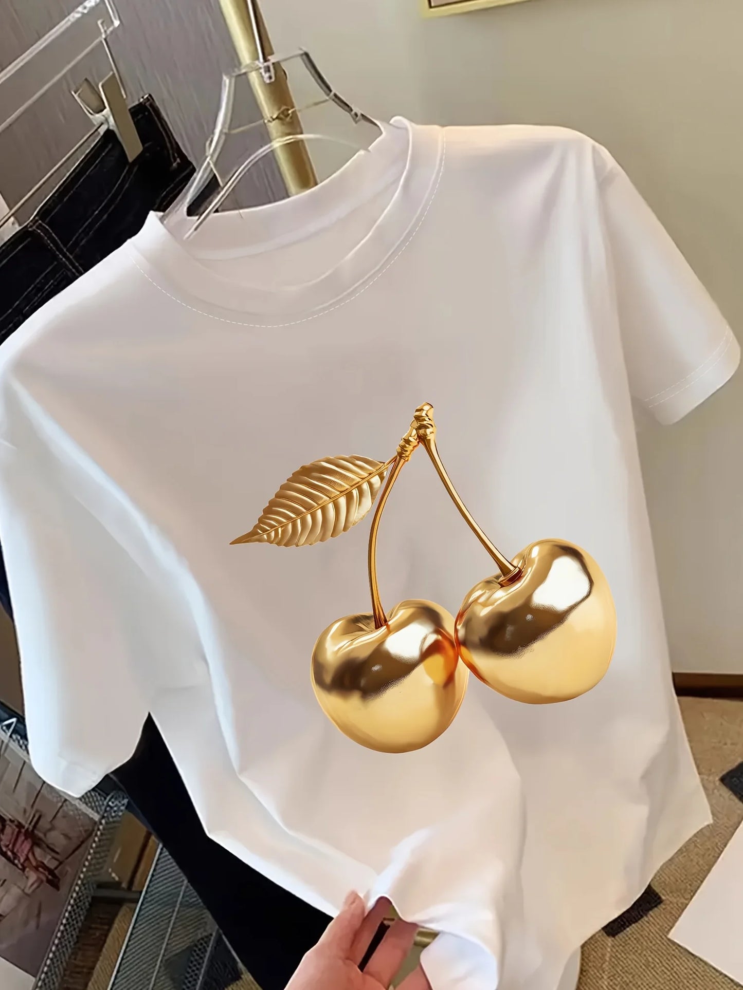 Women's white short sleeve t-shirt with large gold metallic cherry print