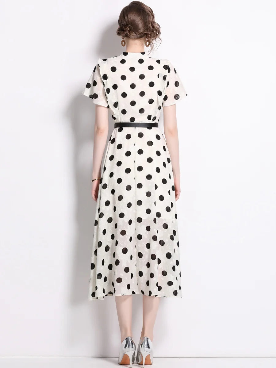 A woman wearing an elegant polka dot dress