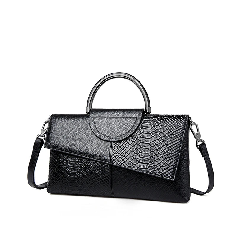 Black handbag with snake skin pattern on a white background
