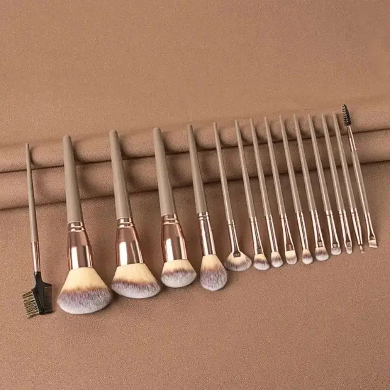 Set of makeup brushes with brown handles and white bristles on a brown background. Soft fluffy makeup brush set with wool fiber bristles and plastic handles. Complete set for powder, foundation, eyeshadow, and beauty blending.