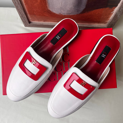 White loafers with red accents on a red box