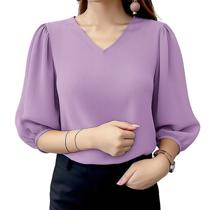 Purple blouse with puffed sleeves worn by a person on a white background