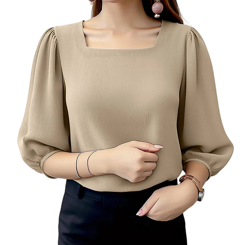 Beige blouse with puffed sleeves worn by a person on a white background