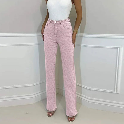 Person wearing pink quilted pants and a white top against a light gray wall. Women’s denim jeans with flower rhinestones, loose wide leg, low waist, light wash. Stylish rhinestone casual trousers for UK fashion lovers.