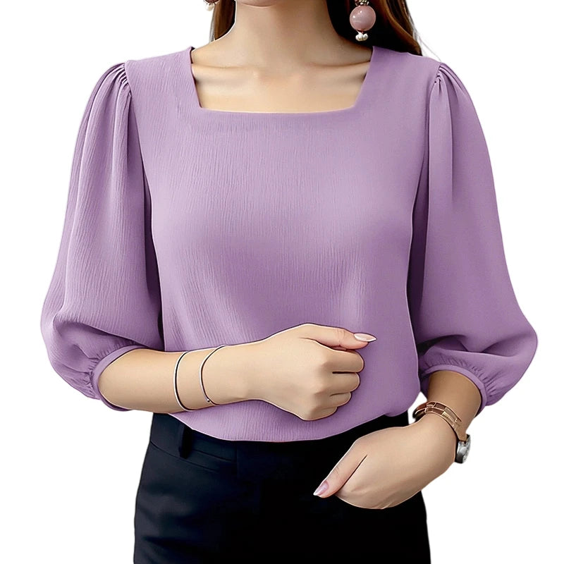 Purple blouse with puffed sleeves worn by a person on a white background