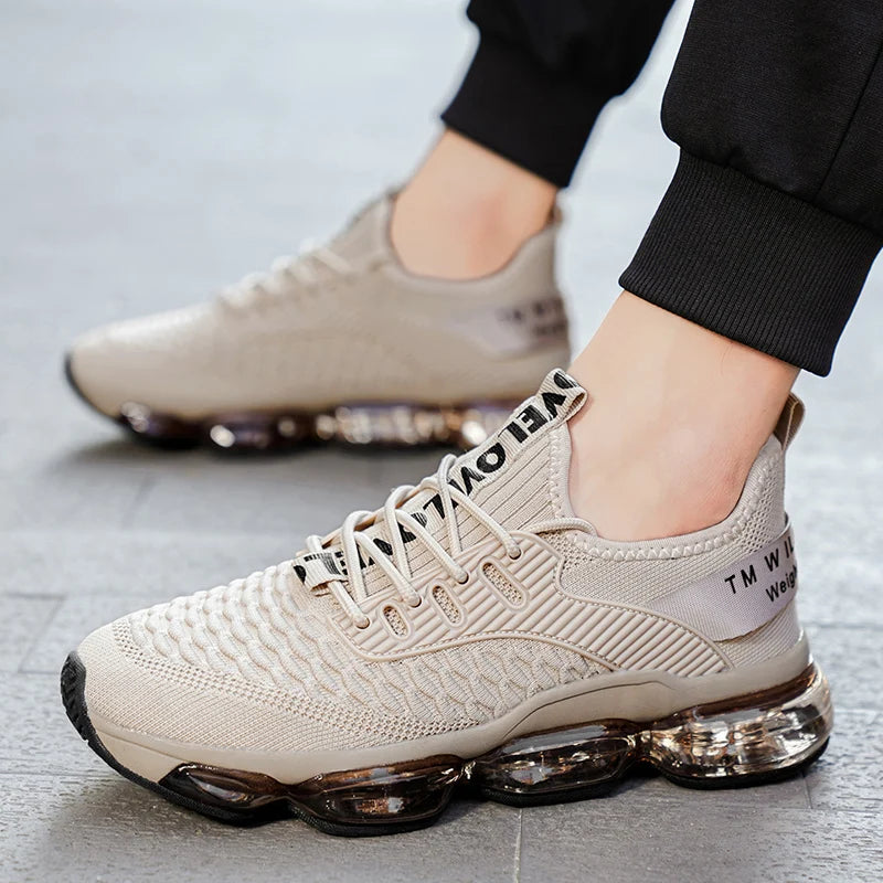 Beige sneakers with air cushion sole worn by a person on a light gray floor.