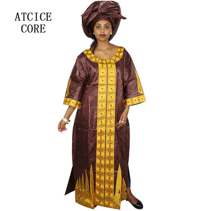 Woman wearing a brown and gold traditional outfit with matching headwrap on a white background.