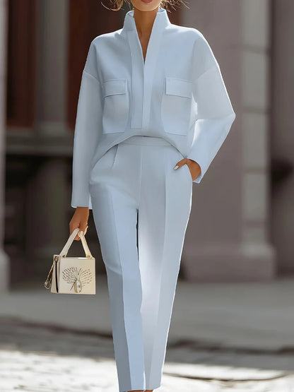 Person wearing a light blue outfit with a blurred background