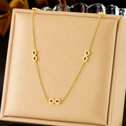 Gold necklace with unique design on a beige box