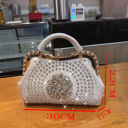 Decorative handbag with rhinestone embellishments on a wooden surface, with measurements indicated.. Large genuine leather dumpling bag with diamond rhinestone clip and lock clasp. Soft handle, multiple compartments. Fashionable shoulder tote for women.