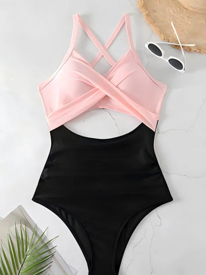 Black swimsuit with pink top on a light gray surface