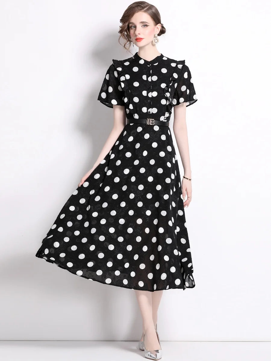 A woman wearing an elegant polka dot dress