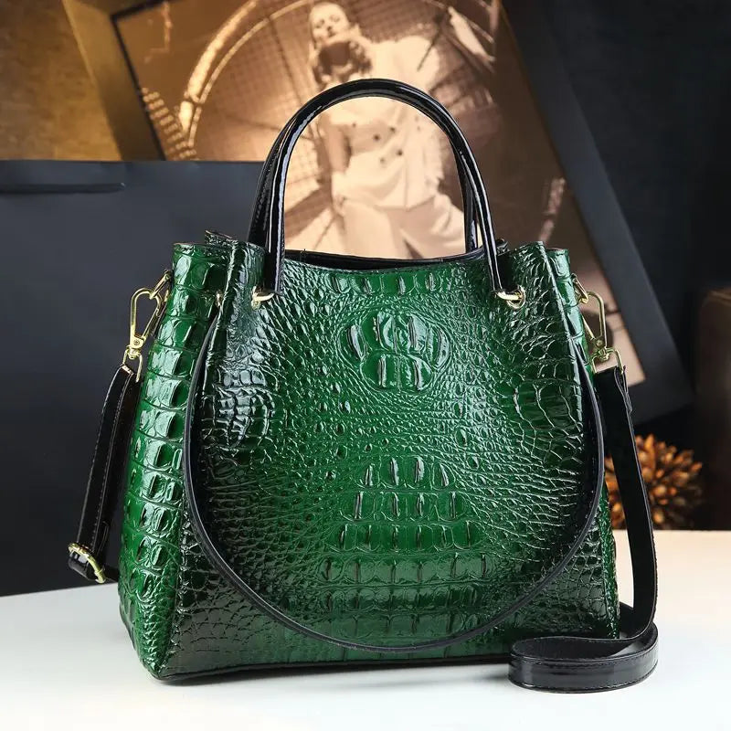 Green textured handbag with black handle and strap on a white surface. Vintage genuine leather bucket tote bag with crocodile print. Soft medium-hardness leather, zipper closure, interior pockets. Stylish crossbody bag UK.