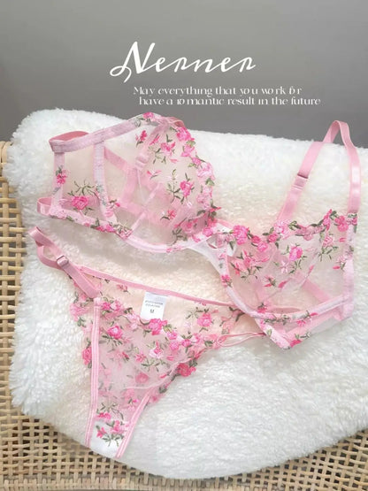 Floral lingerie set on a textured surface with 'Nennes' branding.
